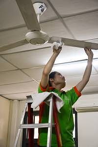 Gabrielle climbing up the ladder to clean one of the fans