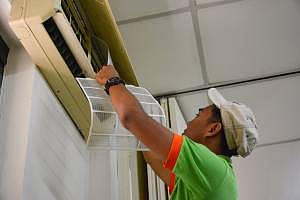 Hadi servicing one of the air-conditioners