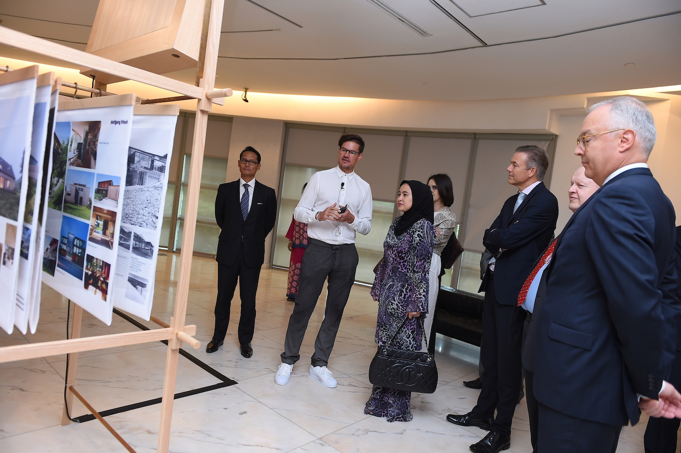 Dr. Wolfgang Fiel (second from left) giving a curatorial walkthrough of the exhibition to guests.