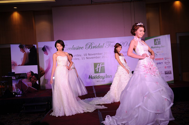 Elegant models strolling down the stage with the latest wedding gown