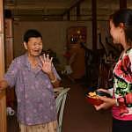 Auspicious moment: Connie Chin, Director of Marketing Communications spending time with one of the residents with Chinese New Year cookies.
