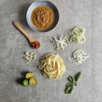Johor laksa ingredients spread out is a Malaysian southern state dish that uses traditional ingredients fused with western noodles like skinny fettuccine