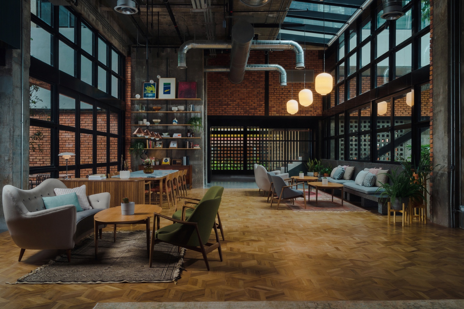The light-filled lobby area at Kloe Hotel – also serving as a café-co-working space – that opens out to a small sunny courtyard and accentuated by bespoke mid-century modern-inspired furniture.