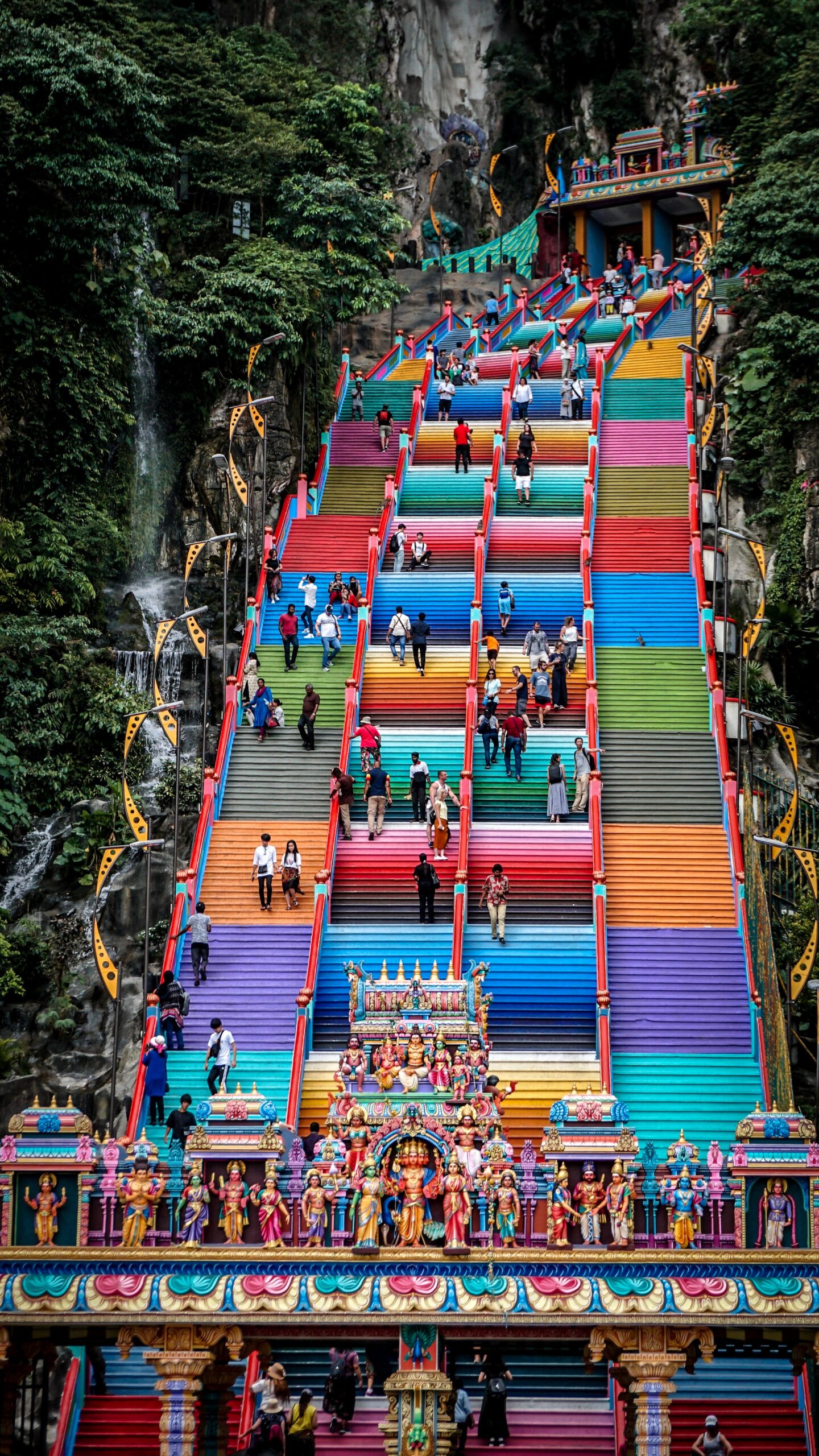 People walking up and down the stairs of Batu Caves