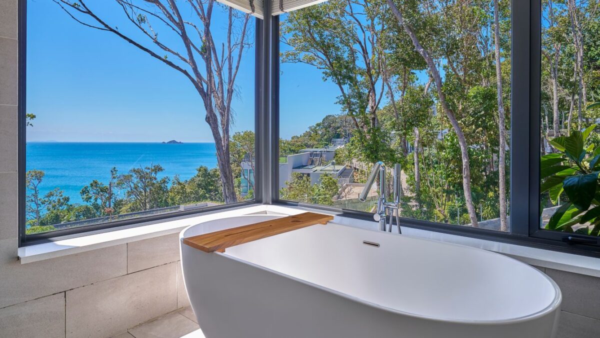 Marriott Resort Perhentian's bathroom with a separate tub and rainfall shower.