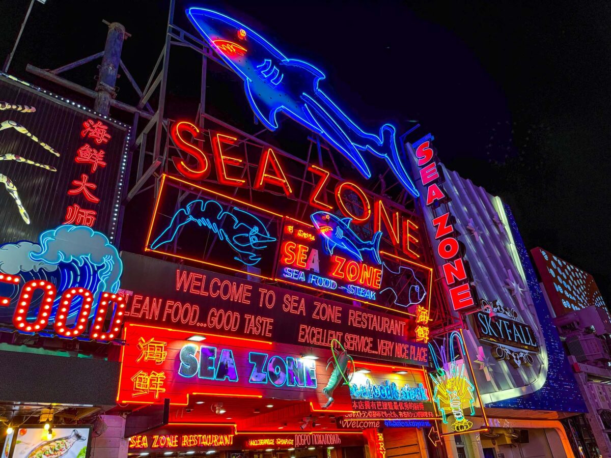 Pattaya Walking Street comes alive after sunset with neon lights and music