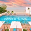 The serene outdoor pool at M Social Resort Penang offers sweeping views of Tanjung Bungah’s coastline — a perfect spot for guests to unwind under the tropical sun.