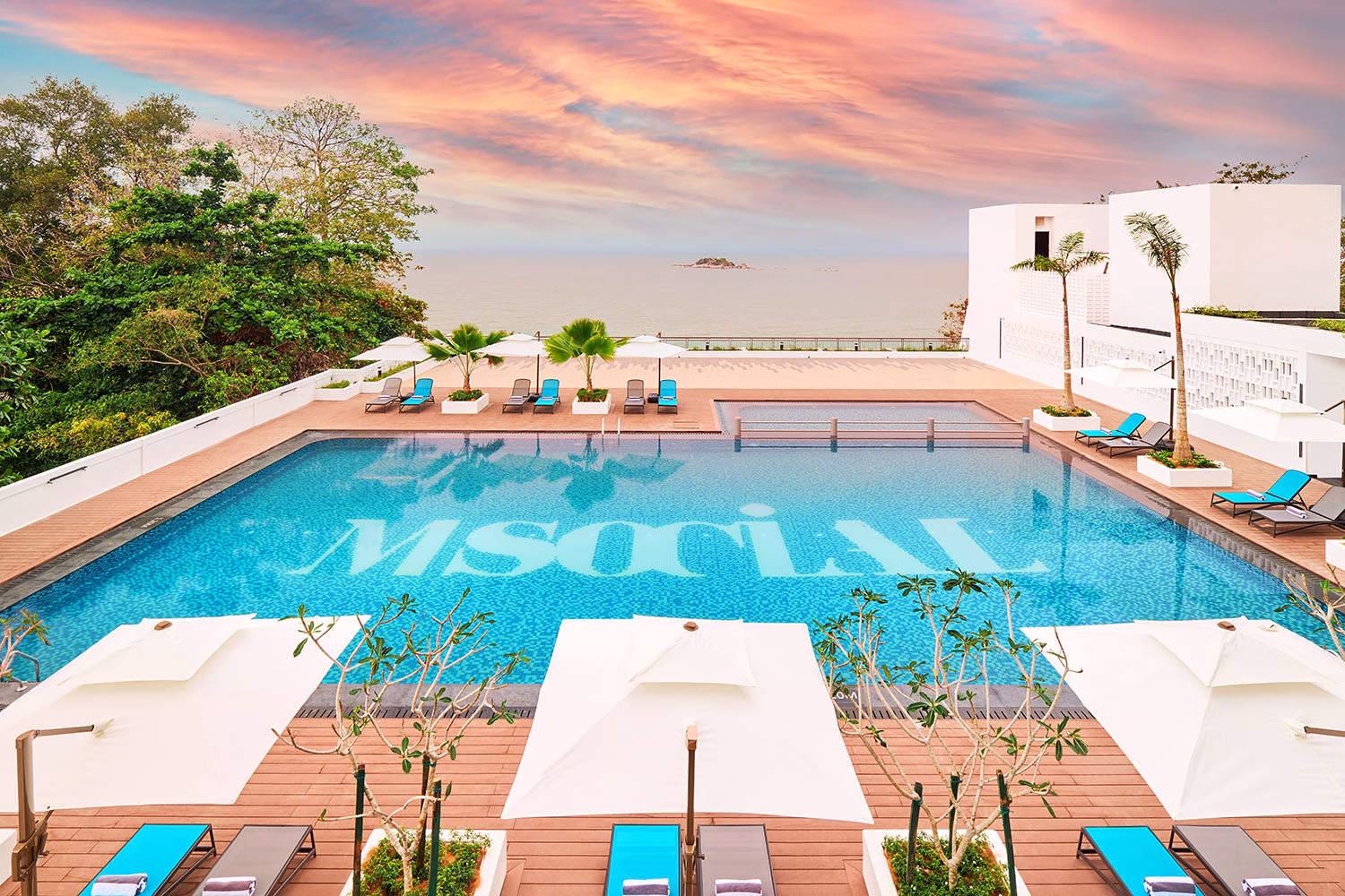 The serene outdoor pool at M Social Resort Penang offers sweeping views of Tanjung Bungah’s coastline — a perfect spot for guests to unwind under the tropical sun.