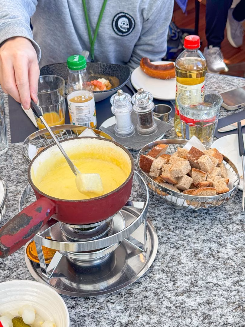 Traditional Swiss cheese fondue served with bread at Restaurant Crystal on Jungfraujoch – Top of Europe, Switzerland.