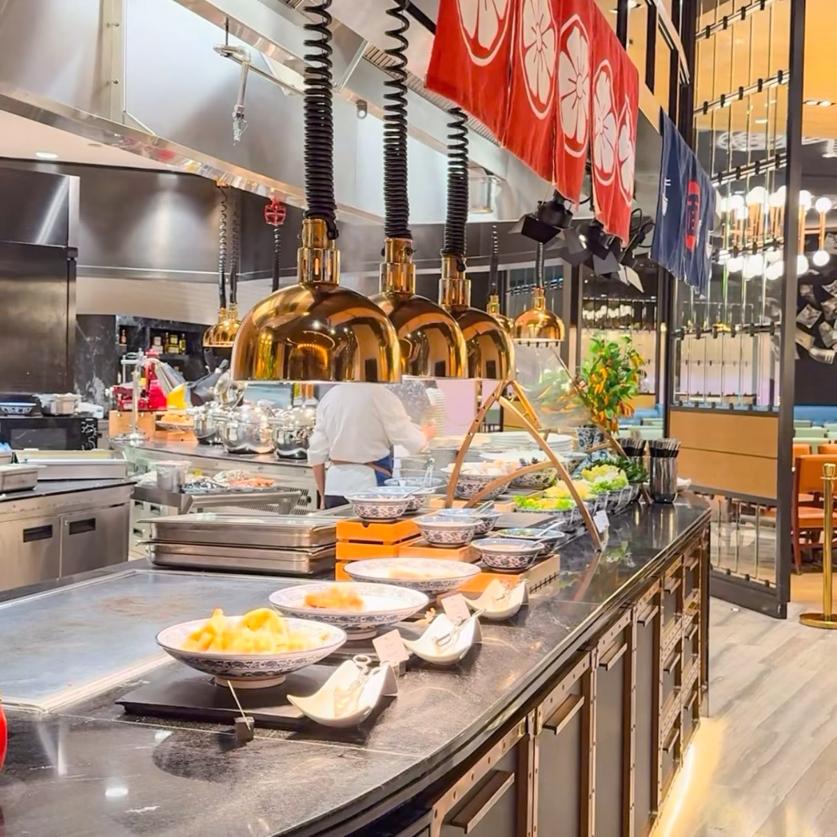 Breakfast buffet counter at Studio City Macau featuring prepared dishes, serving bowls and a live cooking station.